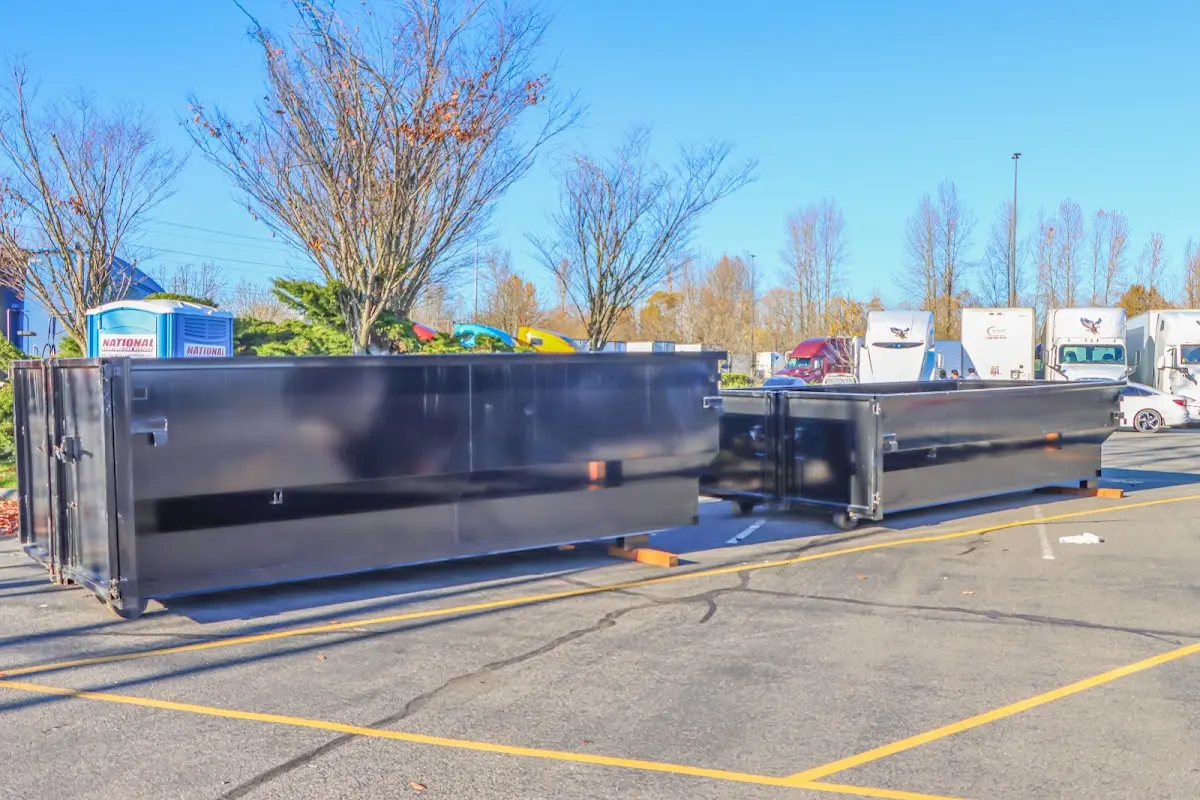 Professional dumpster rental service with roll-off container on residential driveway in Huber Heights